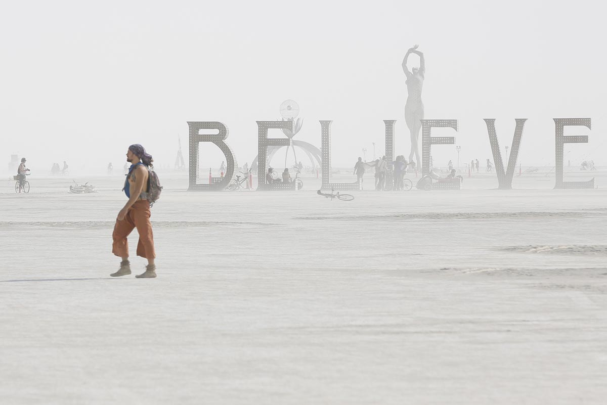 Dust envelops art installations during the Burning Man 2013 arts and music festival in the Black Rock Desert of Nevada