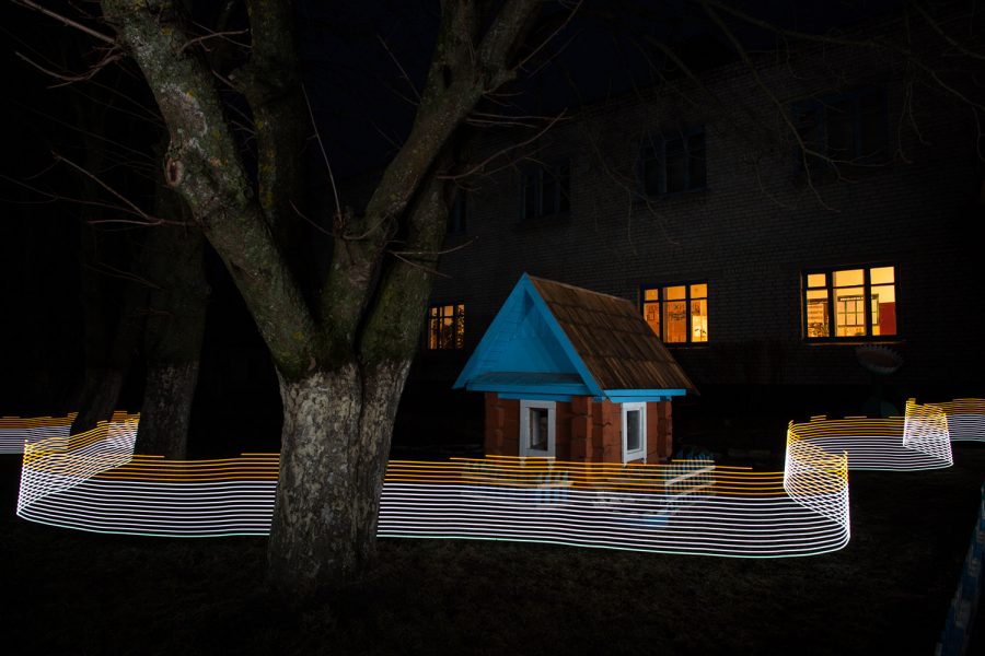 A special light painting tool displays radiation levels in real-time at a school in Starye Bobovichi. Here white light shows contamination levels up to 0.23uSv/h, while orange highlights elevated levels – from 0.30uSv/h to 0.65uSv/h around these trees and children's play house. 30 years after the 1986 Chernobyl nuclear disaster, the schoolyard still contains areas of elevated radiation levels.